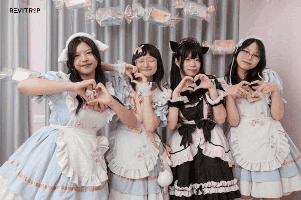 The restaurant staff wear anime-style costumes, reflecting Japanese culture, to welcome customers.