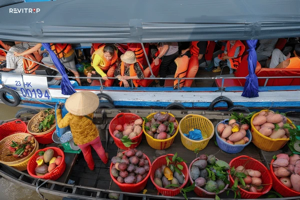 Cai Rang floating market Can Tho at sunrise with colorful trading boats loaded with fresh produce on the river