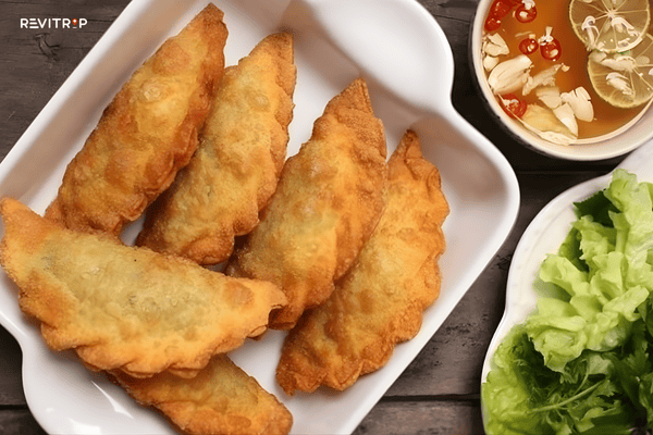 Deep-fried pillow cake banh goi Sapa street food with pork and mushroom filling served with dipping sauce