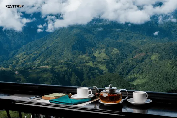 Swing Sapa cafe terrace with outdoor seating, hot coffee, and panoramic valley and mountain view