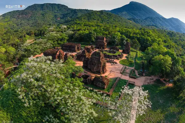 A wider valley scene showing the sanctuary surrounded by hills
